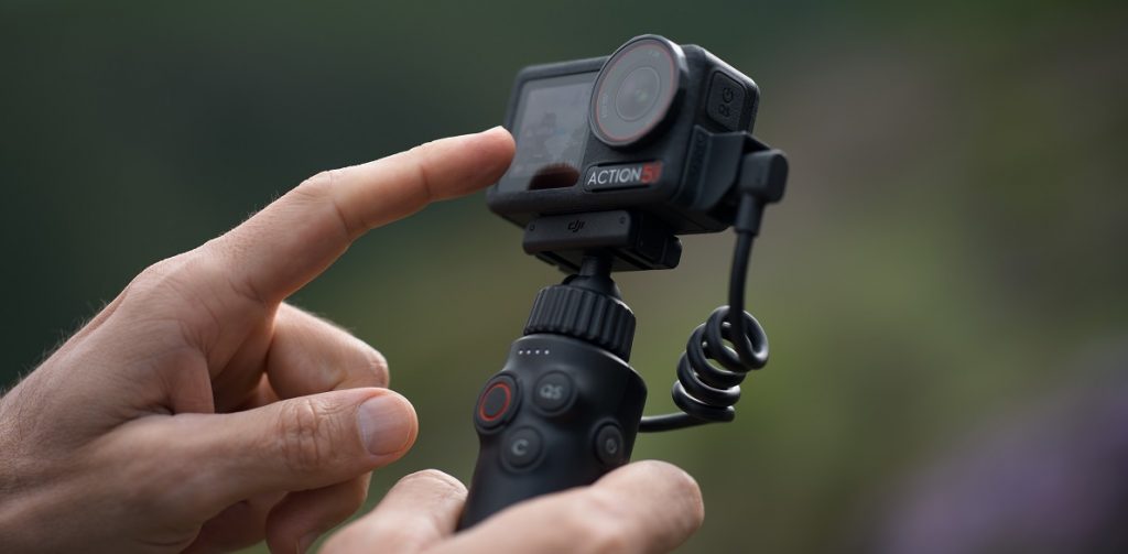 Finger berührt Touchscreen der neuen DJI Osmo Action 5 Pro Actioncam